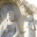 Marble relief of Shakyamuni Buddha with two attendants, carved in raw stone
