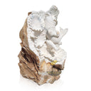 Half raw stone statue of child holding a koi fish