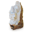 Half raw stone statue of child holding a koi fish