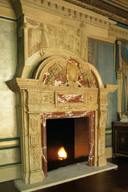 Grand marble fireplace mantel with a regal arched pediment