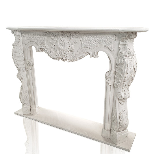 White marble fireplace mantel with intricate floral scrollwork and lattice-style carvings