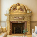 Grand marble fireplace mantel with a regal arched pediment