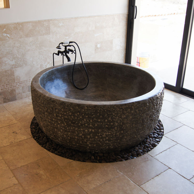 Round tub hand-carved from brown marble Japanese soaking tub style